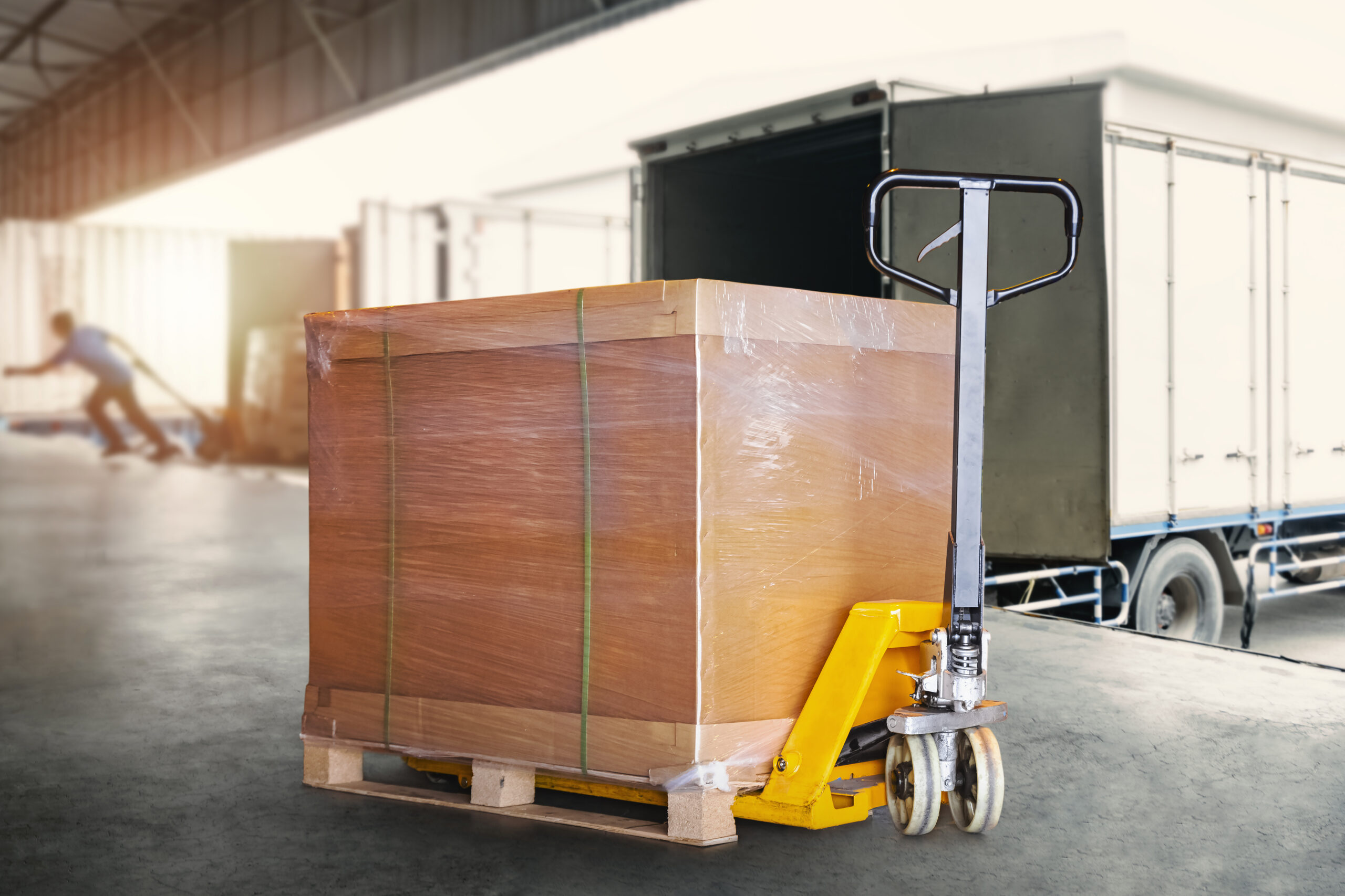 packaging-boxes-wrapped-plastic-pallet-with-hand-pallet-truck-shipping-warehouse-cargo-transport